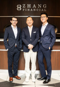 Tyler Soares, Charles Zhang, and Alex Zhang, standing together in the lobby of Zhang Financial.